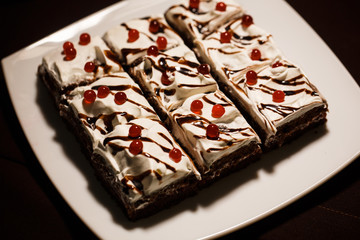 chocolate cakes with butter cream decorated with red jelly berries