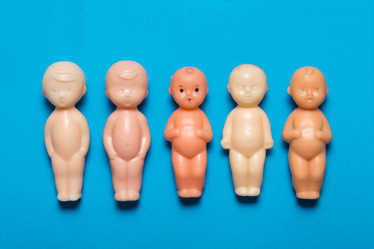 Lot of frozen plastic dolls on blue background
