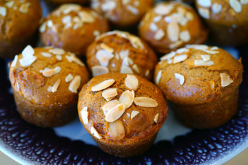 Platter of homemade vegan pumpkin muffins with almonds