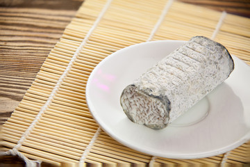 Fresh brie cheese with white mold on a white background