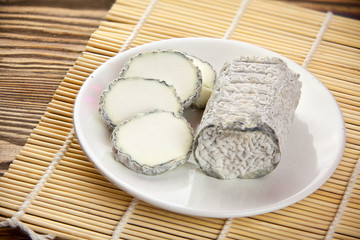 Fresh brie cheese with white mold on a white background