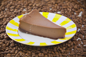 chocolate cheesecake on white plate on  wooden table