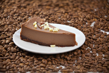 chocolate cheesecake on white plate on  wooden table