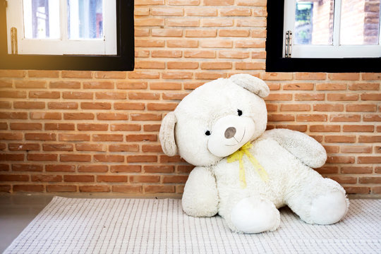 White teddy Bear, Placed in, brick wall background