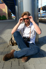 Travelling and youth. Man with smiling face on train station