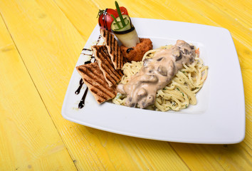 Main course concept. Pasta with white sauce and decor