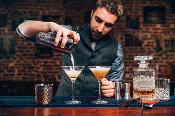 Barman creating professional cocktails. Details of alcoholic drinks and beverages at pub or bar