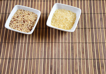 bowl of raw rice on bamboo tablecloth 