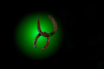 HorseShoe rusty steel on dark background