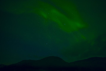 Night photo. Silhouette of the mountain and the northern lights.Iceland.
