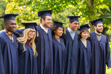 happy students or bachelors in mortar boards