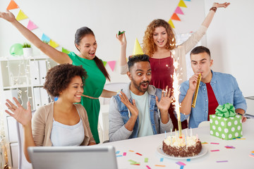 office team greeting colleague at birthday party