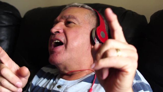 Happy Senior Man Listening Music
