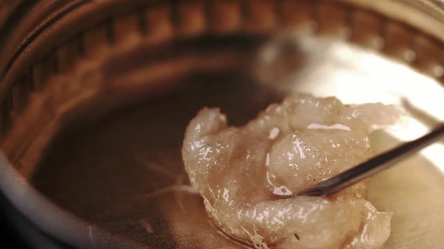 Taking in a drugs in a syringet hrough a piece of cotton.