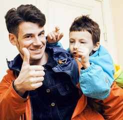 young handsome father with his son fooling around at home, lifes