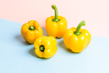 Yellow bell peppers or sweet pepper.or paprika on blue and pink background