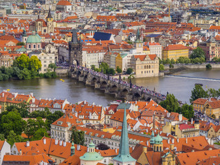 Panoramic view of old (Stare Mesto) and lesser (Mala Strana) town from St. Vitus Cathedral, with red roofs and Charles bridge through Vltava river, Prague, Czech Republic
