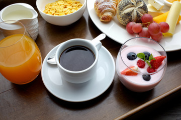 Rich continental breakfast. French crusty croissants, muesli, lots of sweet fruits and berries, hot coffee for morning meals.