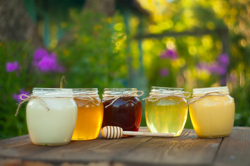 Delicious delicious honey in  jar on table