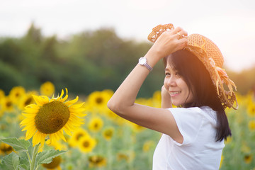 Freeedom woman on blooming sunflower field