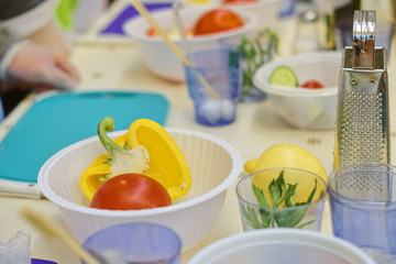 Fresh vegetables for preparing salad. On the kitchen table when conducting culinary training in the preparation of salad from fresh vegetables.