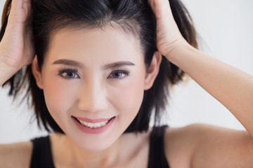 Fototapeta premium beautiful asian girl casual costume ralax on white bed next to window curtian with sunlight beauty skin concept