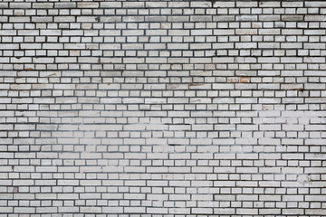 Fototapeta na wymiar Background rough brick wall painted with white paint