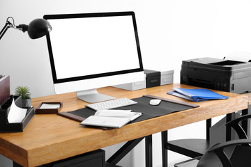 Fototapeta premium Comfortable workplace with computer monitor on table in office
