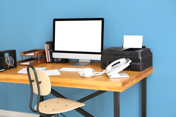 Comfortable workplace with computer monitor on table in office