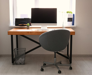Comfortable workplace with computer monitor on table in office