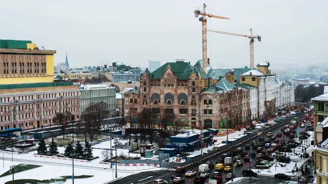 Moscow, Russia. Aerial view of popular landmarks - Polytechnic Museum and other - in Moscow, Russia. Time-lapse during the day with car traffic jam in Moscow. Construction cranes. Zoom out