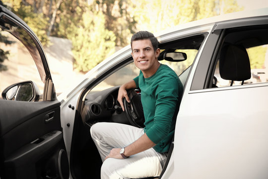 Young man on driver seat of car