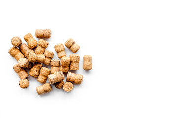 Corks of wine bottles on white background top view copyspace