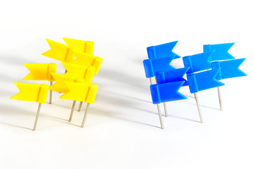 antagonism concept made from marking flag pins on white background