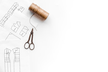 Tailor's work desk. Pattern of clothing and tools on white background top view copyspace