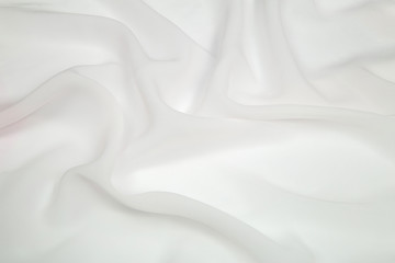 Obraz premium bright white square light fabric spread out in soft folds on the table