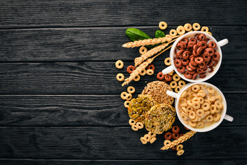 Fitness breakfast, muesli, milk, fruits, nuts and seeds, on a wooden surface. Top view. Free space for text.