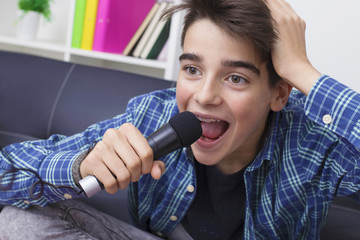 children, teenager or preteen with the microphone singing at home