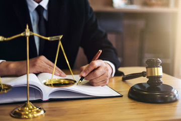 Fototapeta na wymiar Judge gavel with Justice lawyers, Businessman in suit or lawyer working on a documents. Legal law, advice and justice concept