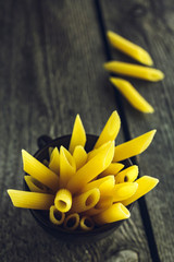 Bright yellow pasta penne close-up