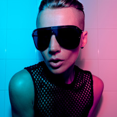 Tomboy Girl with short hair and luxury sunglasses. Fashion Party Style Club neon light