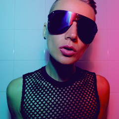 Tomboy Sexy Girl with short hair and luxury sunglasses. Fashion Party Style Clubbing neon light
