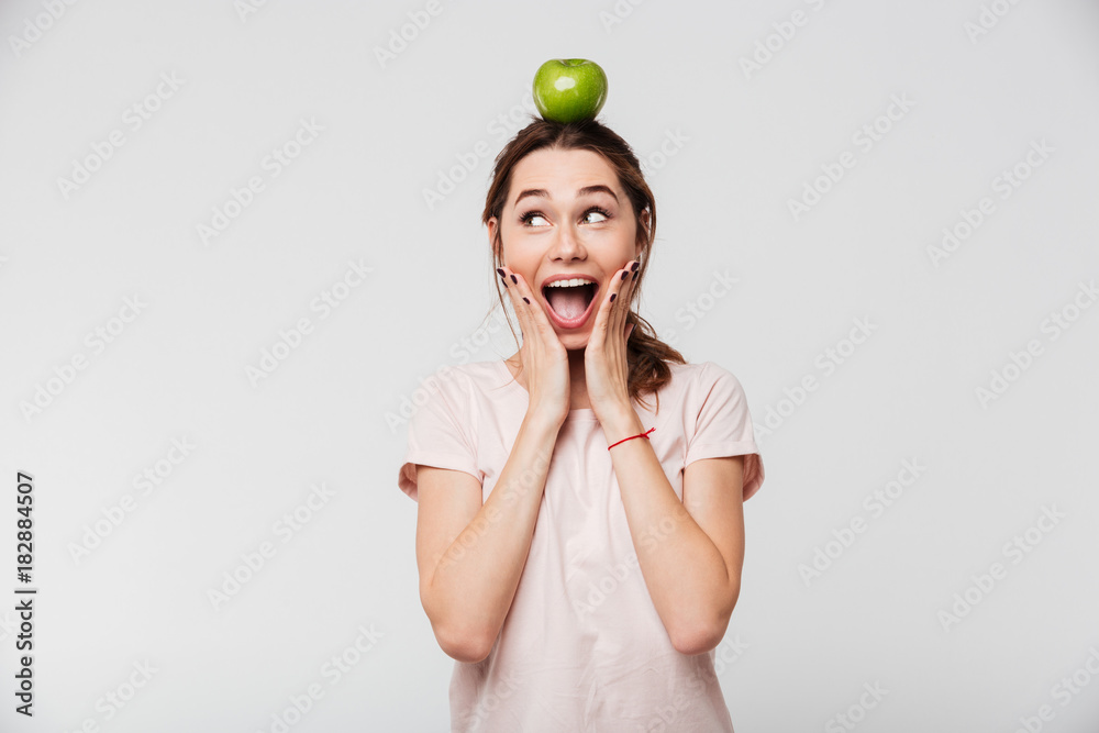 Sticker portrait of a cheerful happy girl holding apple