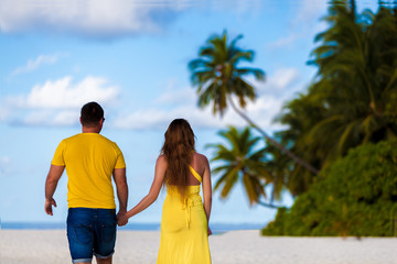 Maldives, a couple walking along the beach