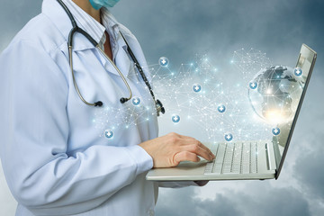 Doctor working on laptop in the network.