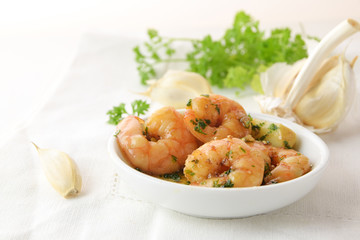 shrimps with garlic, olive oil and parsley in sherry sauce in a white bowl, spanish tapas appetizer...