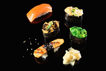 Salmon and mussels, salad shrimp, chuka, Japanese omelette sushi, dark background. Concept menu of a Japanese restaurant.