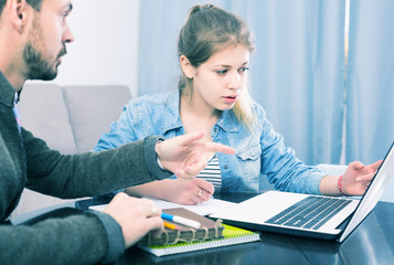 tutor explaining material to his female client at home
