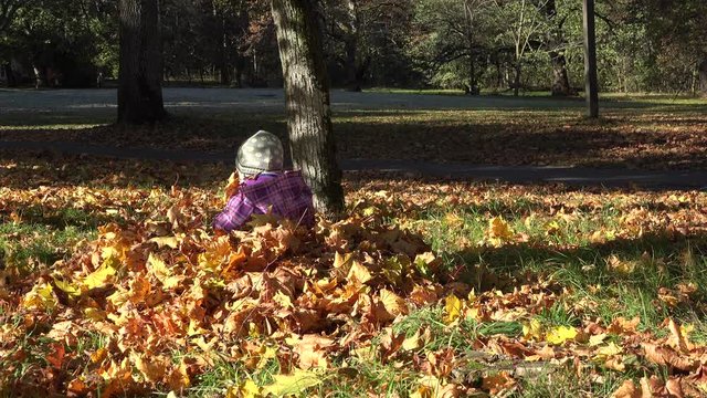 Baby kid and beautiful mother playing outdoor in autumn park. 4K