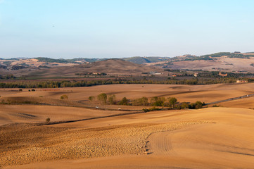 Beautiful rural autumn landscape of Val d'Orcia on the background Pienza, Tuscany, Italy.